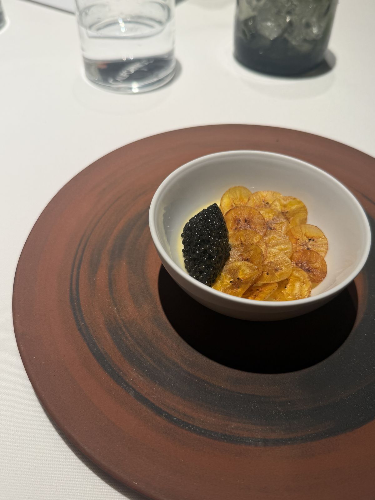 Grilled banana flan topped with caviar and plantain chips at Californios