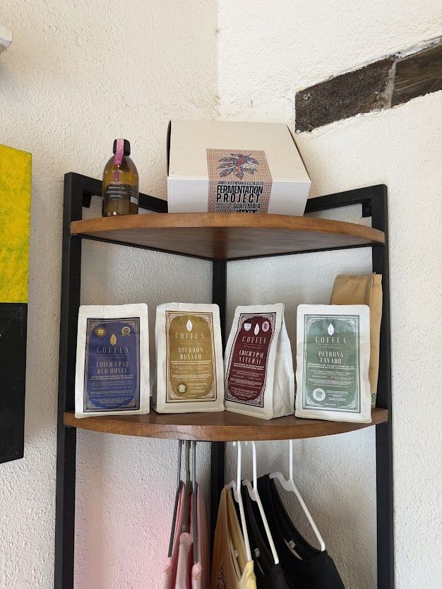 Coffea coffee bags on a corner shelf, with a Fermentation Project box on top