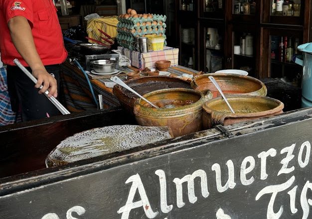 Clay pots of guisados on the counter