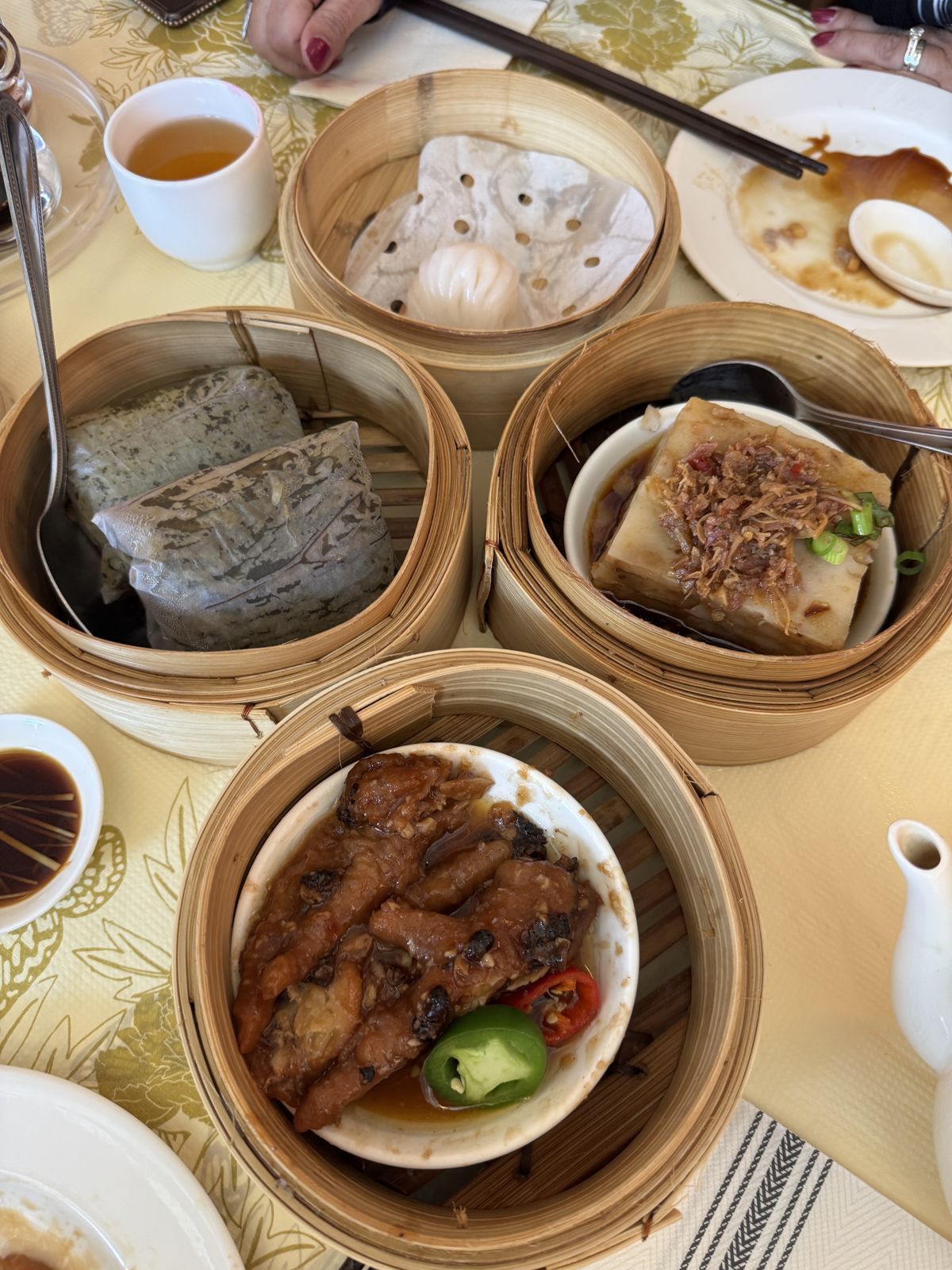 Chicken feet with sliced chili, sticky rice parcels, a radish cake with dried shrimp and a shrimp dumpling in bamboo steamers at HK Lounge Bistro