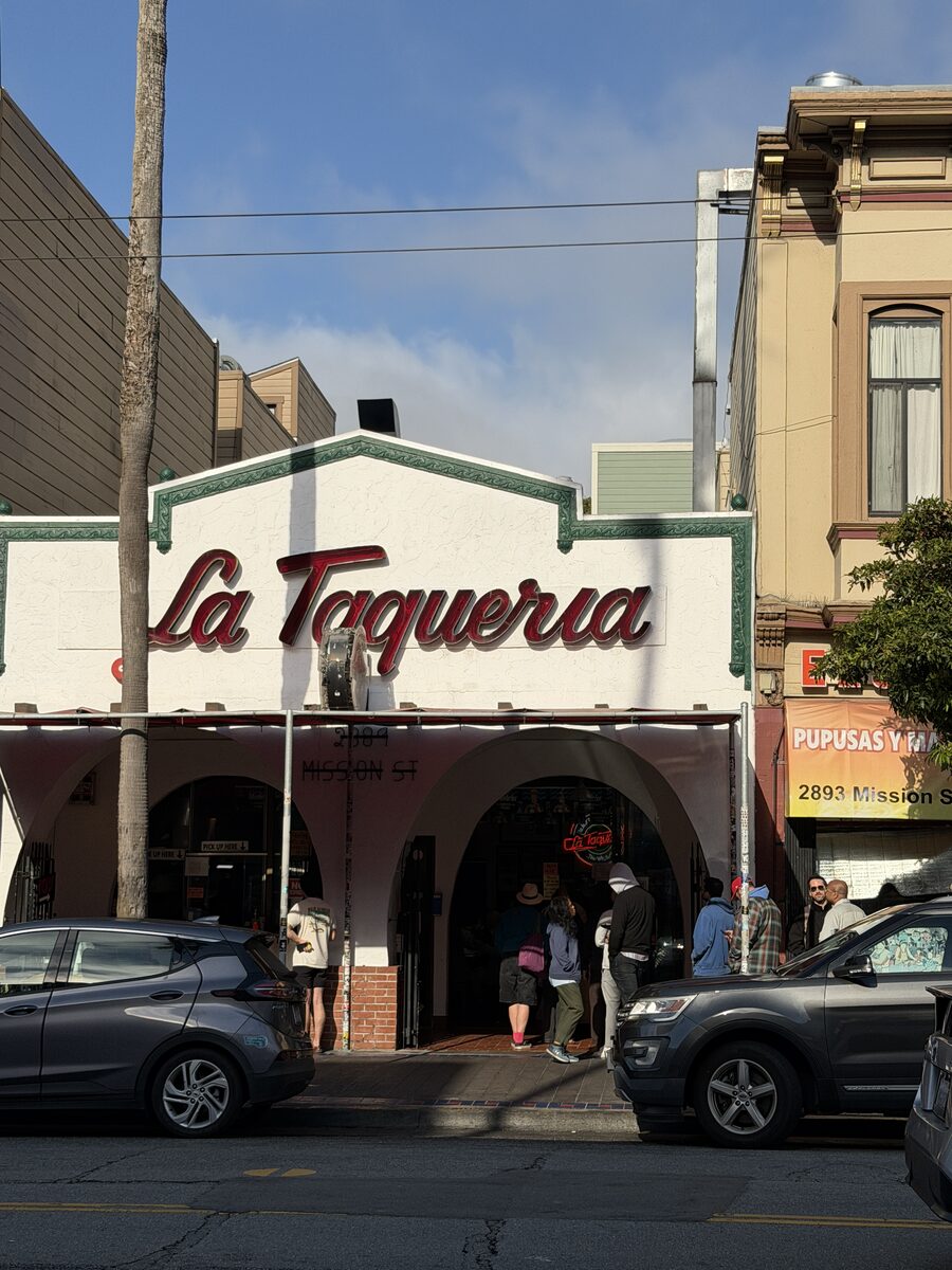 La Taqueria's Mission Street facade and the line forming outside